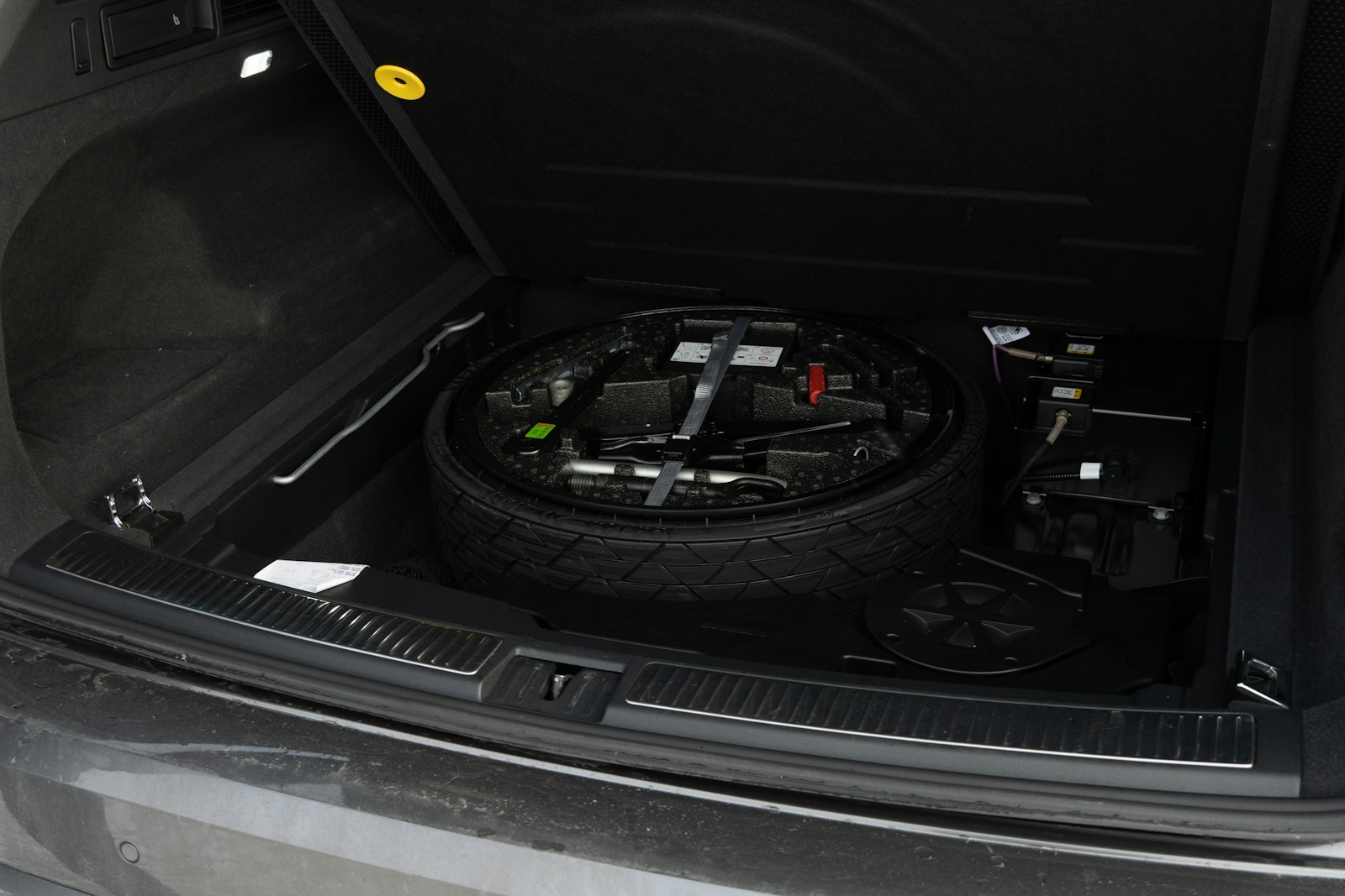Spare tire and tools in car trunk